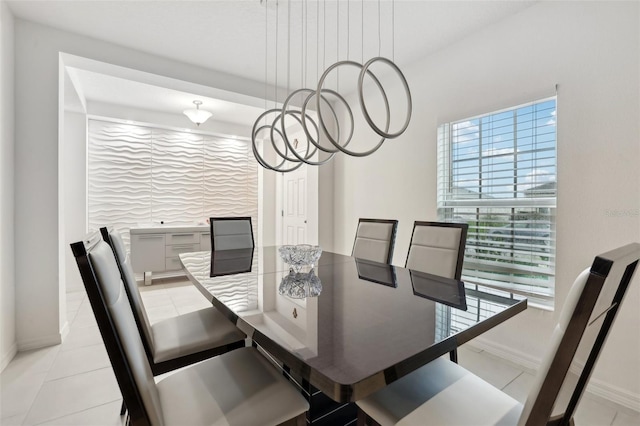 dining space featuring plenty of natural light, baseboards, and light tile patterned floors