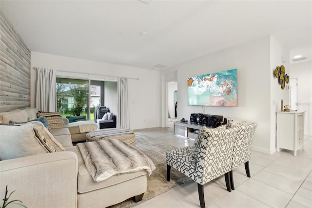 living area with light tile patterned floors and baseboards