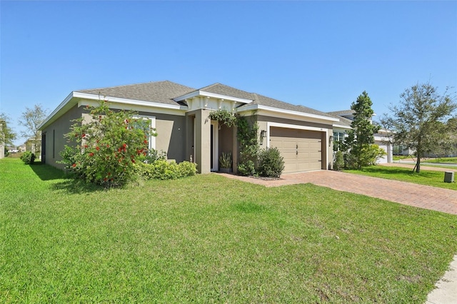 view of front of house with stucco siding, a front lawn, decorative driveway, a shingled roof, and a garage