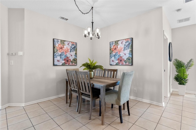 dining room with light tile patterned floors, a chandelier, and visible vents