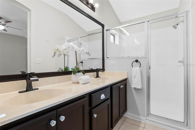 full bath with double vanity, a stall shower, tile patterned flooring, and a sink