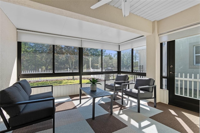 sunroom featuring ceiling fan