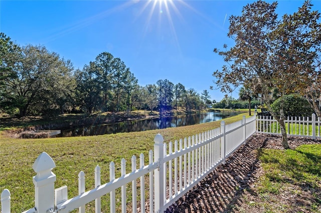 view of yard featuring a water view and fence