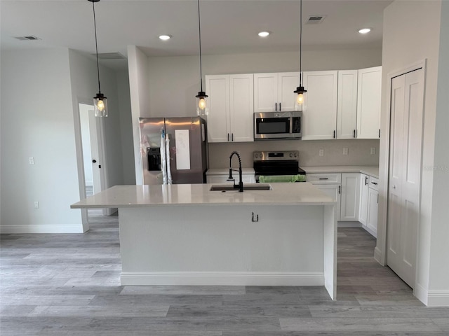 kitchen with stainless steel appliances, a sink, visible vents, and decorative backsplash