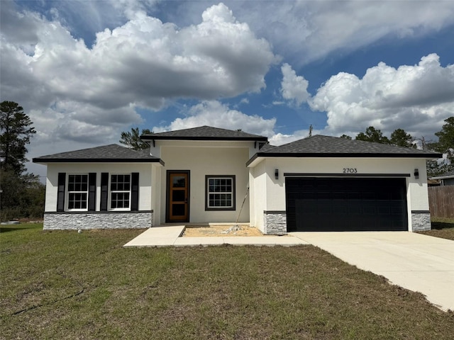 view of front of property with a garage, driveway, stone siding, a front yard, and stucco siding