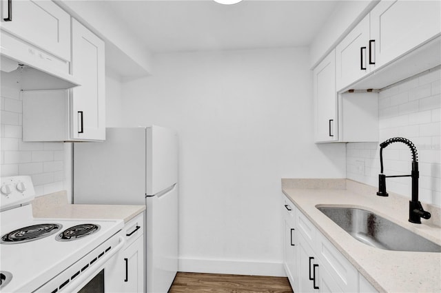 kitchen with white range with electric cooktop, decorative backsplash, white cabinetry, a sink, and under cabinet range hood