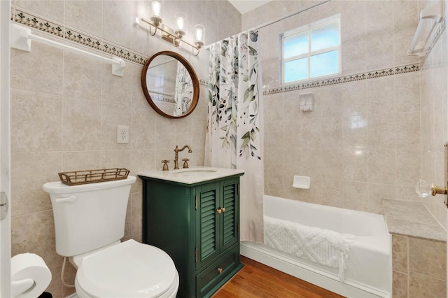 bathroom featuring shower / bath combo, tile walls, toilet, and wood finished floors