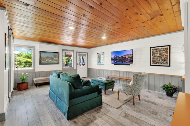 living room with wooden ceiling, a wall mounted air conditioner, and wood finished floors