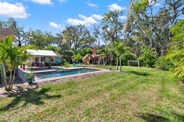 pool featuring a playground, a lawn, and a patio