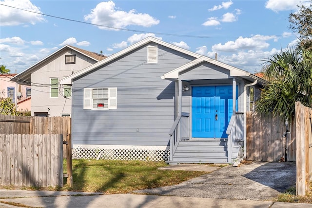 bungalow-style home featuring entry steps and fence