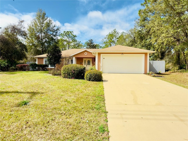 single story home featuring an attached garage, fence, concrete driveway, stucco siding, and a front yard