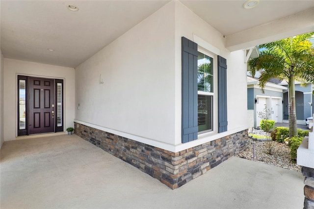 entrance to property featuring stucco siding