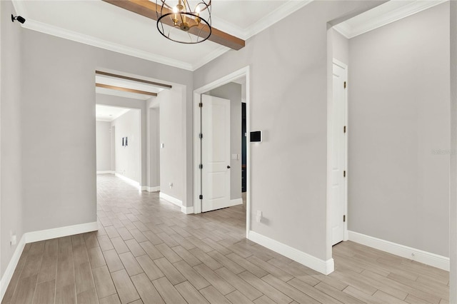 interior space with a notable chandelier, ornamental molding, light wood-type flooring, and baseboards