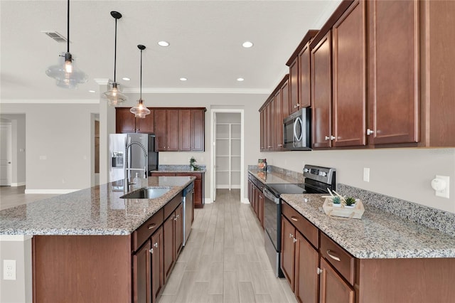 kitchen with visible vents, stainless steel appliances, a sink, and ornamental molding