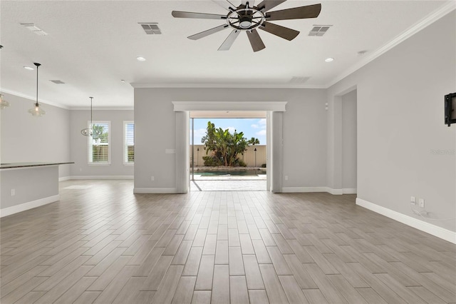 unfurnished room featuring ornamental molding, wood finished floors, visible vents, and a ceiling fan