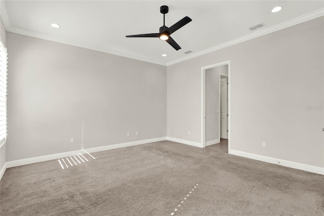 spare room featuring ornamental molding, carpet, visible vents, and baseboards