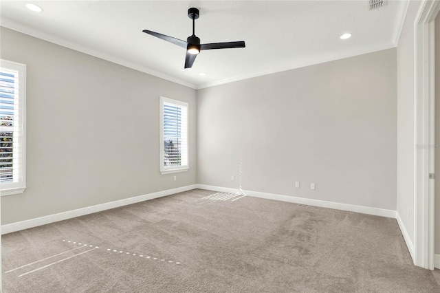 carpeted spare room with baseboards, ceiling fan, recessed lighting, and crown molding