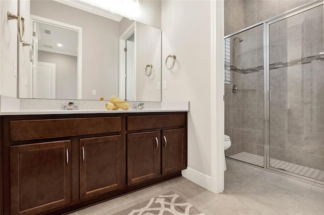 bathroom featuring double vanity, toilet, a stall shower, a sink, and tile patterned flooring