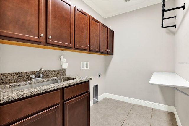 clothes washing area with washer hookup, a sink, baseboards, cabinet space, and electric dryer hookup