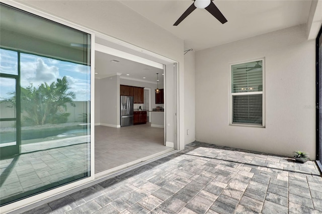 view of patio featuring ceiling fan