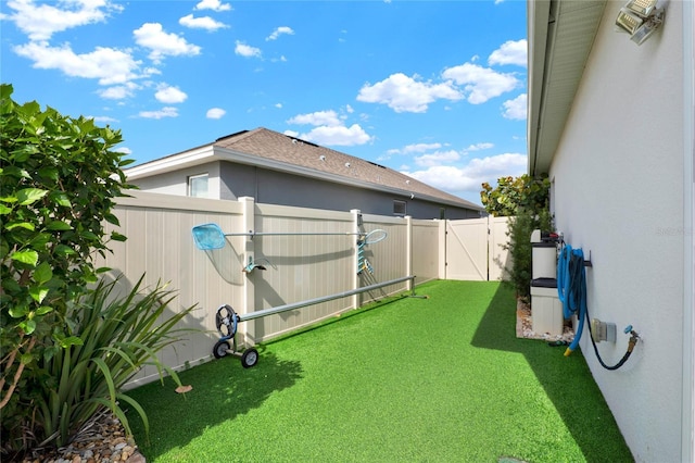 view of yard with a gate and a fenced backyard