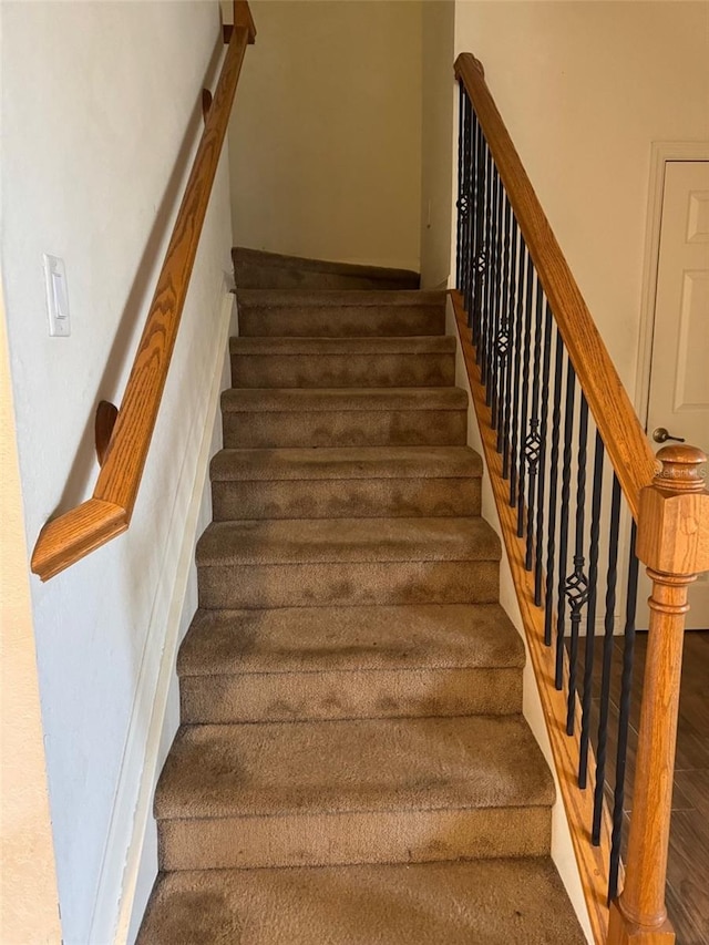 staircase with wood finished floors