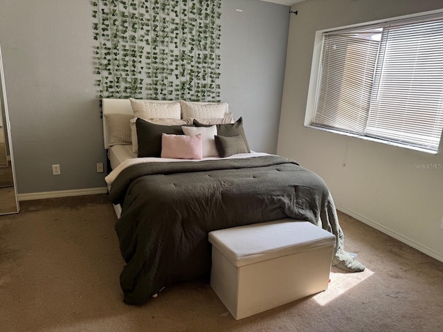 carpeted bedroom featuring baseboards