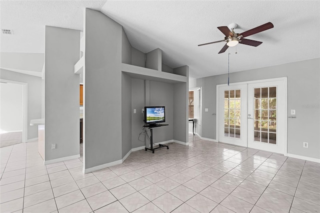 unfurnished living room featuring french doors, ceiling fan, a textured ceiling, and light tile patterned floors