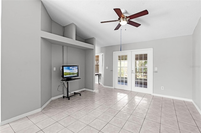 unfurnished living room featuring light tile patterned floors, ceiling fan, baseboards, vaulted ceiling, and french doors