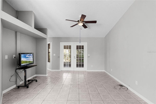 unfurnished living room featuring baseboards, lofted ceiling, ceiling fan, french doors, and light tile patterned flooring