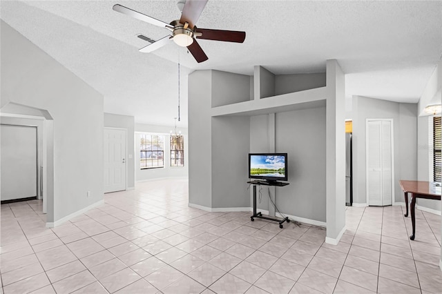 unfurnished living room featuring light tile patterned floors, visible vents, lofted ceiling, a textured ceiling, and ceiling fan with notable chandelier