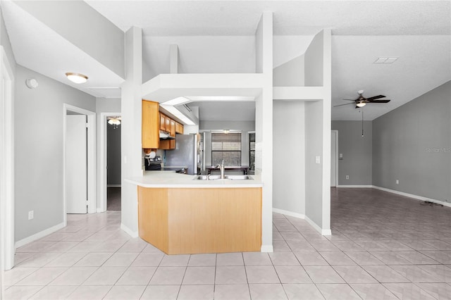 kitchen featuring ceiling fan, light tile patterned flooring, a sink, and stainless steel electric stove