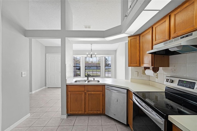 kitchen featuring under cabinet range hood, a sink, visible vents, appliances with stainless steel finishes, and an inviting chandelier