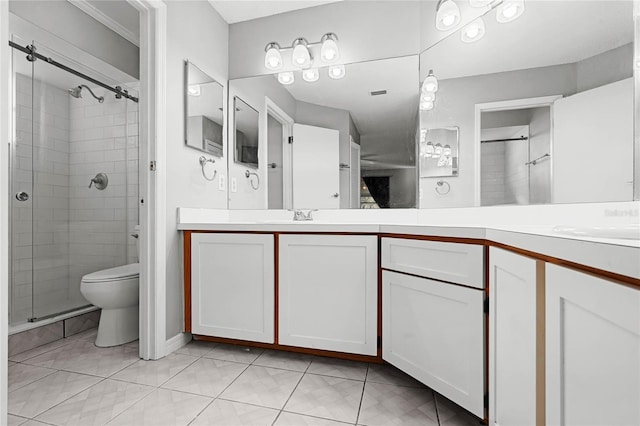 full bathroom featuring double vanity, a stall shower, a sink, and toilet