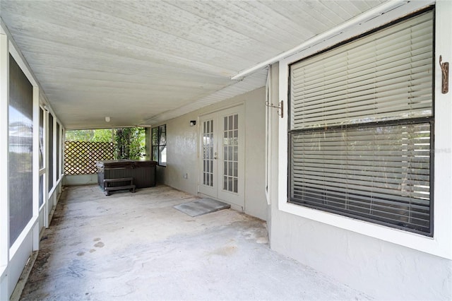 unfurnished sunroom with french doors