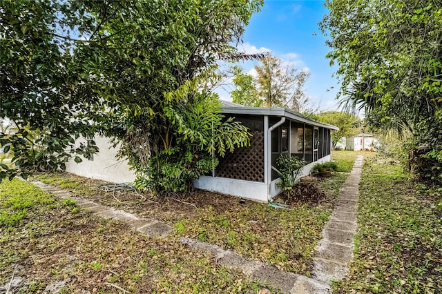 view of side of property with a sunroom