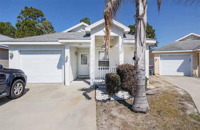 single story home with roof with shingles, stucco siding, a porch, concrete driveway, and a garage