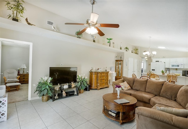 living room with ceiling fan with notable chandelier, lofted ceiling, visible vents, and light tile patterned floors