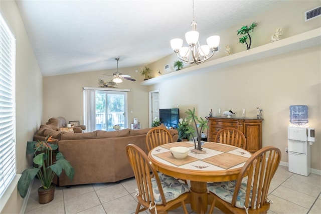 dining area featuring light tile patterned floors, visible vents, vaulted ceiling, baseboards, and ceiling fan with notable chandelier