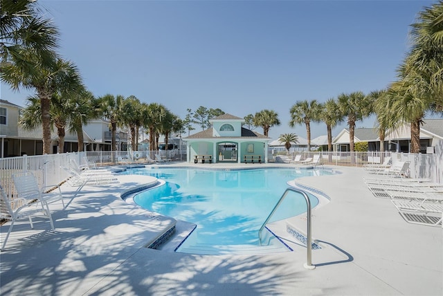 pool with fence and a patio