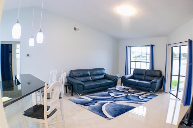 living area with visible vents and vaulted ceiling