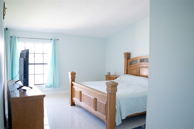 bedroom with baseboards and a textured ceiling