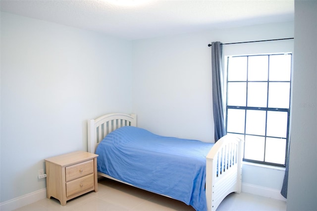 bedroom with multiple windows and baseboards