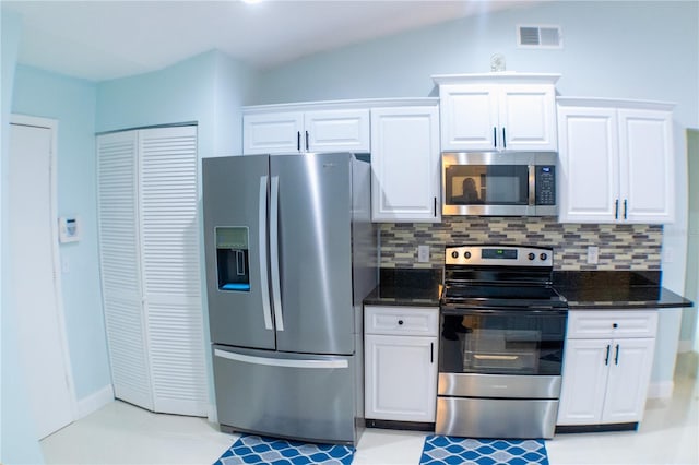 kitchen with appliances with stainless steel finishes, white cabinets, and visible vents