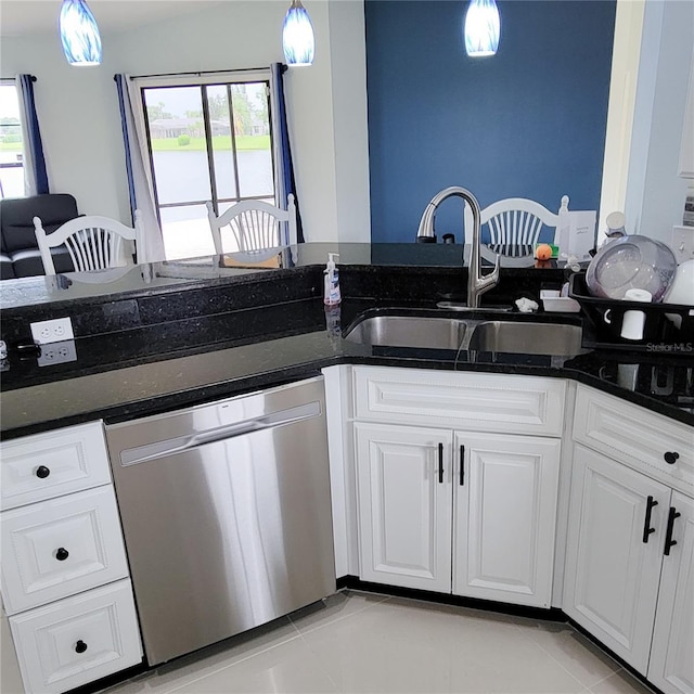 kitchen featuring hanging light fixtures, white cabinets, a sink, light tile patterned flooring, and dishwasher