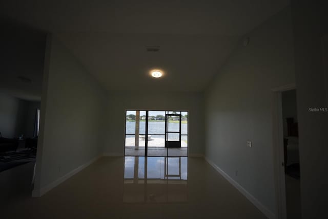 14712 Eagles Crossing Dr, Orlando, FL 32837 - tiled spare room featuring a water view, baseboards, and lofted ceiling