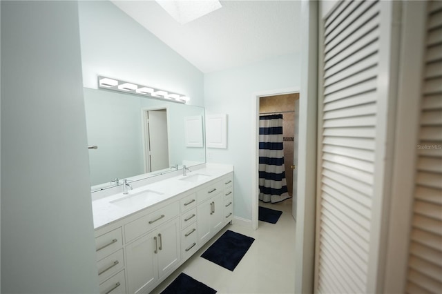 14712 Eagles Crossing Dr, Orlando, FL 32837 - full bathroom with lofted ceiling, double vanity, a closet, and a skylight