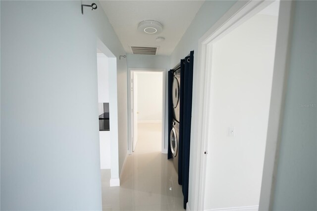 14712 Eagles Crossing Dr, Orlando, FL 32837 - hall featuring estacked washer and dryer and baseboards