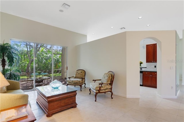 living room with recessed lighting, visible vents, arched walkways, baseboards, and light tile patterned flooring