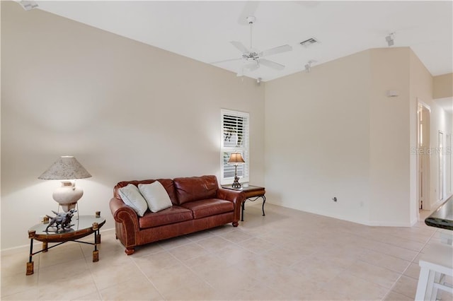 living area featuring light tile patterned floors, ceiling fan, and visible vents